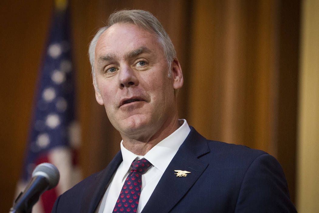 Secretary of the Interior Ryan Zinke speaks after an order withdrawing federal protections for countless waterways and wetland was signed, at EPA headquarters in Washington on Dec. 11, 2018. (AP P ...