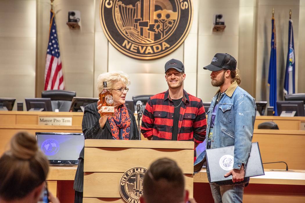 Las Vegas Mayor Carolyn Goodman accepts a bottle of Old Camp Whiskey from Tyler Hubbard and Brian Kelley of Florida Georgia Line at City Hall she proclaims Dec. 11, 2018 Florida Georgia Line Day ...