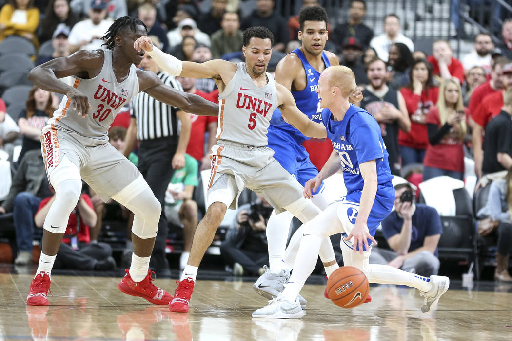 UNLV Rebels guard Noah Robotham (5) defends against Brigham Young Cougars guard TJ Haws (30) during the first half of an NCAA college basketball game at T-Mobile Arena in Las Vegas on Saturday, De ...