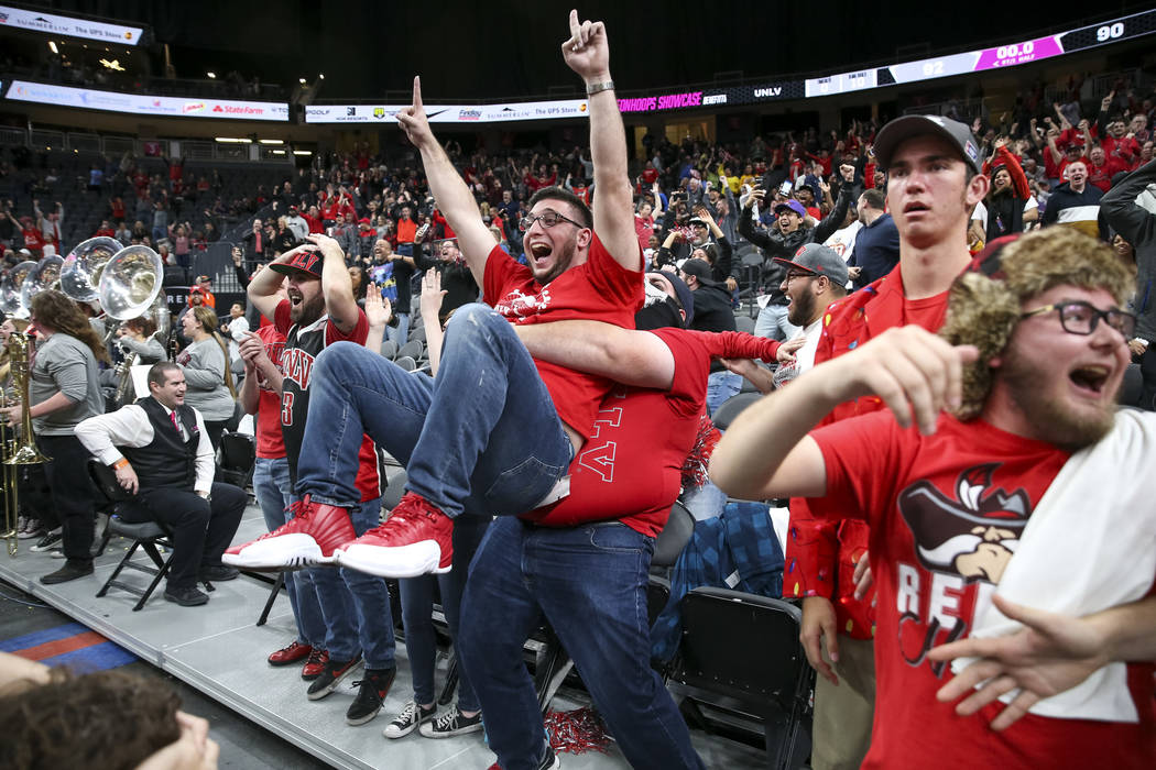 UNLV Rebels fans celebrate the game-winning shot by Rebels guard Noah Robotham (5) to defeat the Brigham Young Cougars 92-90 following an NCAA college basketball game at T-Mobile Arena in Las Vega ...