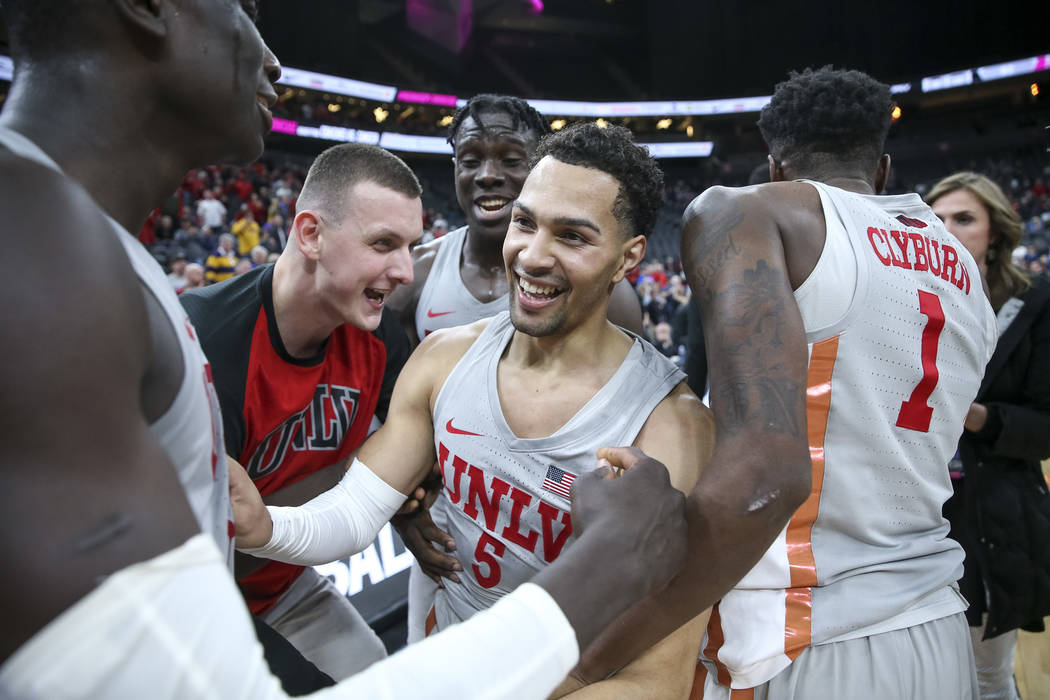 UNLV Rebels guard Noah Robotham (5) is congratulated by his teammates after scoring the game-winning shot to defeat the Brigham Young Cougars 92-90 following an NCAA college basketball game at T-M ...