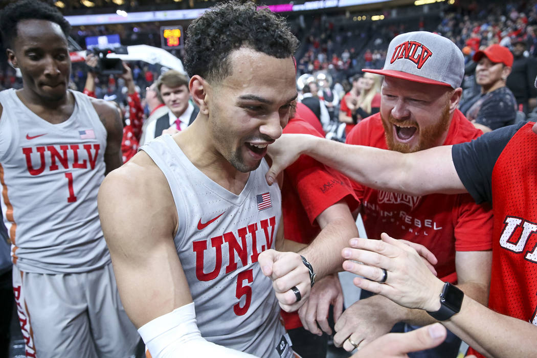 UNLV Rebels guard Noah Robotham (5) is congratulated by fans as he leaves the court after scoring the game-winning shot to defeat the Brigham Young Cougars 92-90 following an NCAA college basketba ...