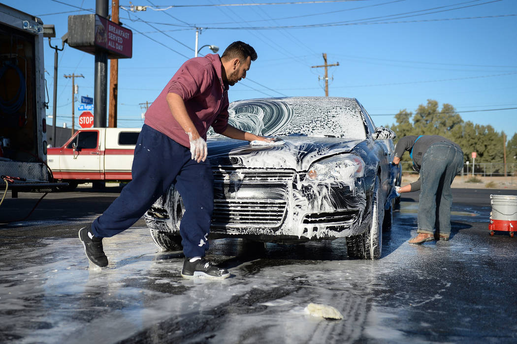 Joel Morales, a friend of Jonathan Garcia, who died Wednesday after falling outside Trump hotel, washes down a car during a carwash fundraiser in Las Vegas, Sunday, Dec. 16, 2018. Caroline Brehman ...