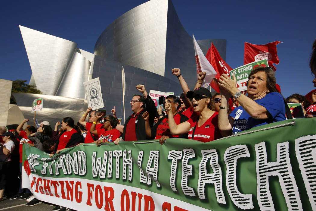 United Teachers Los Angeles leaders are joined by thousands of teachers, who may go on strike against the nation's second-largest school district next month, as they march past the Walt Disney Con ...