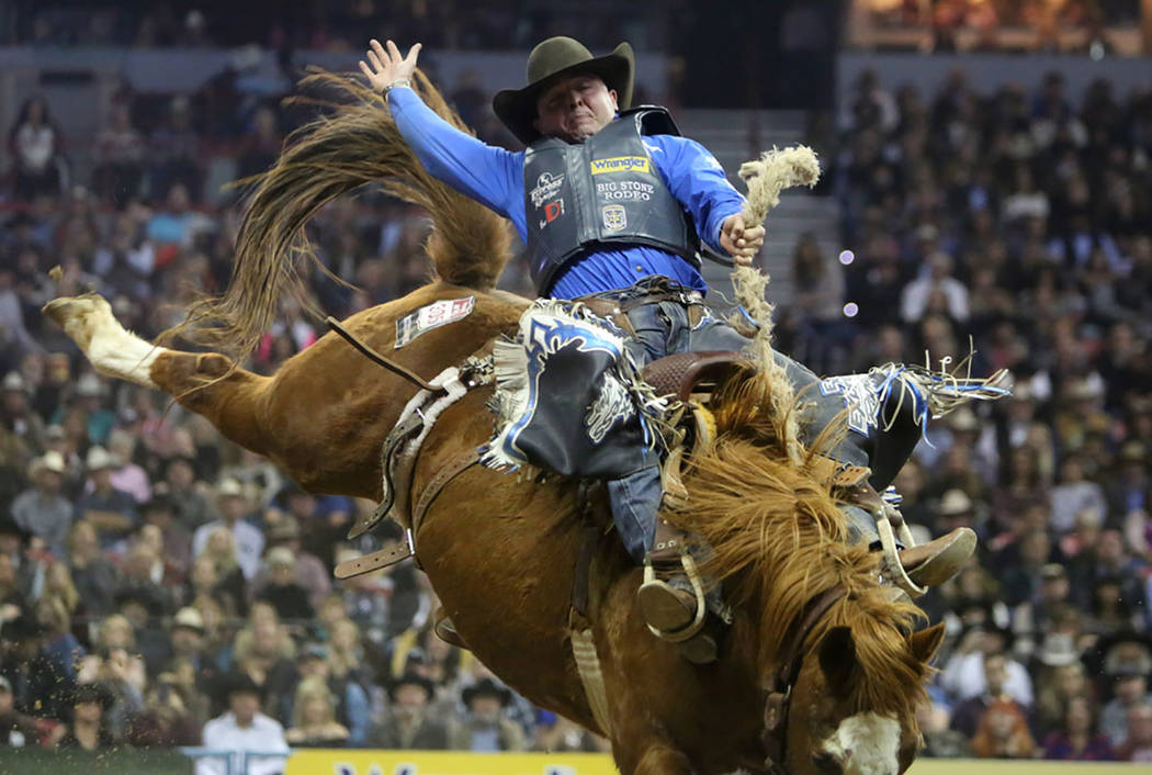 Jake Wright of Milford, Utah competes in the saddle bronc riding event during the tenth go-round of the National Finals Rodeo at the Thomas & Mack Center in Las Vegas, Saturday, Dec. 15, 2018. ...