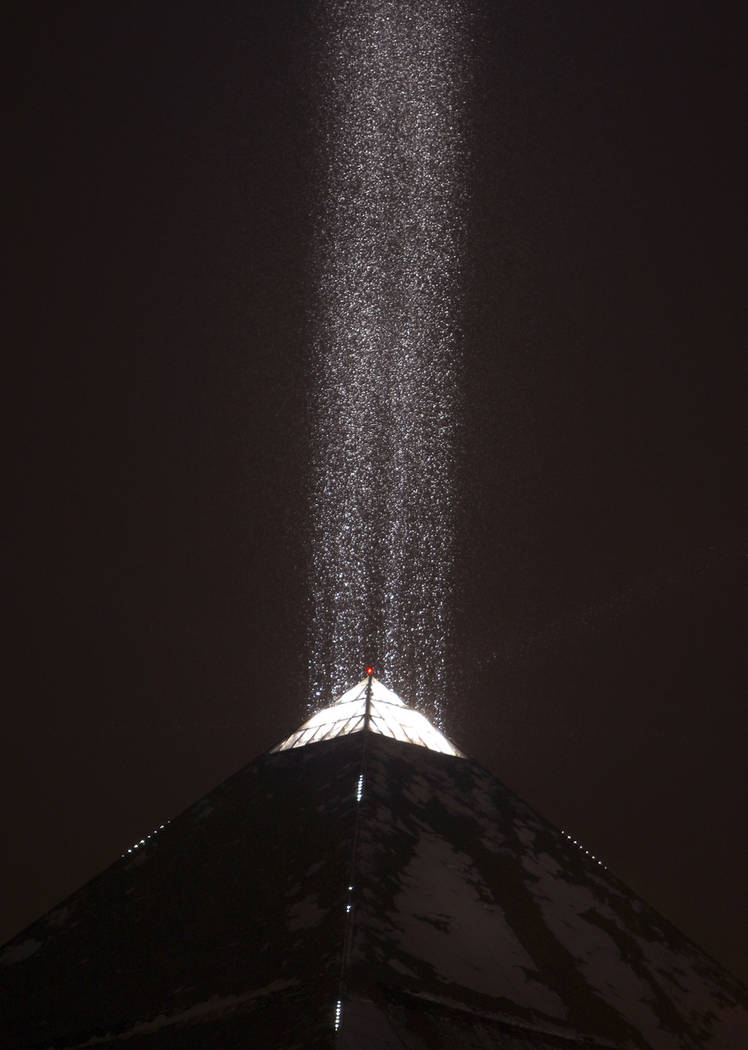 The light atop the Luxor illuminates falling snow on the Las Vegas Strip on Dec. 17, 2008. (Las ...