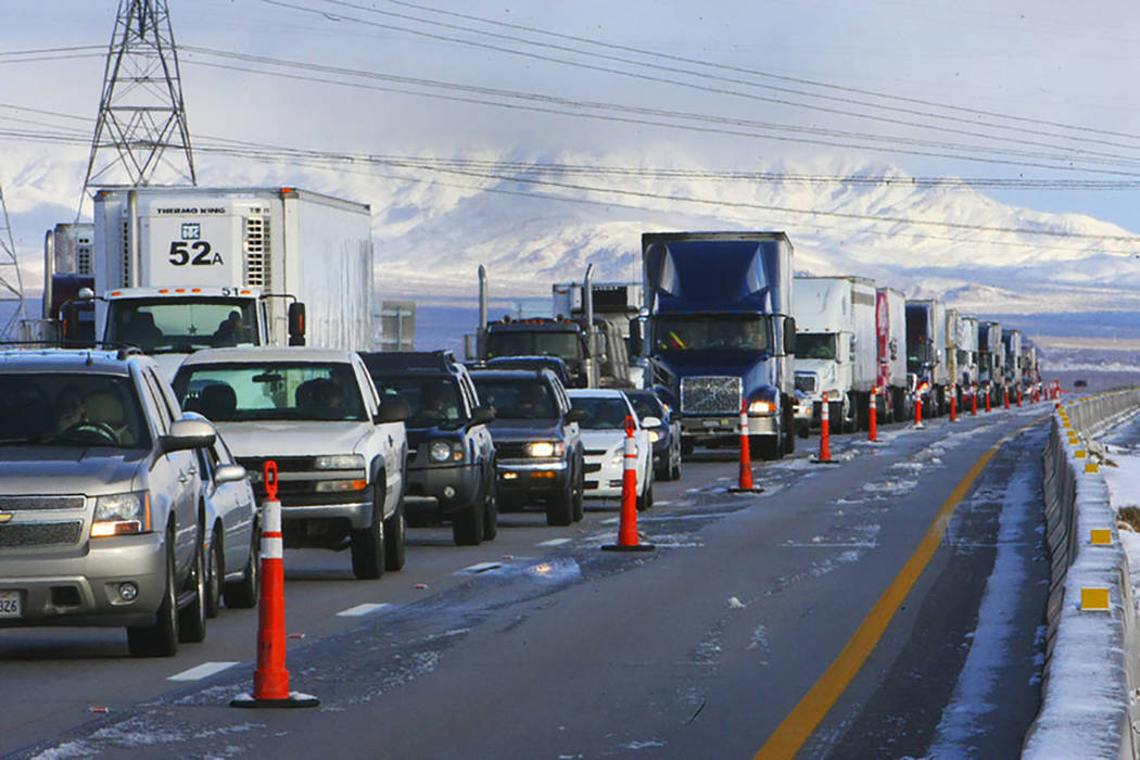 A line of semi tractor-trailers and other vehicles are parked on Interstate 15 in Primm on Dec. 18, 2008, after the interstate was closed due to the winter storm that passed through the area. (Las ...