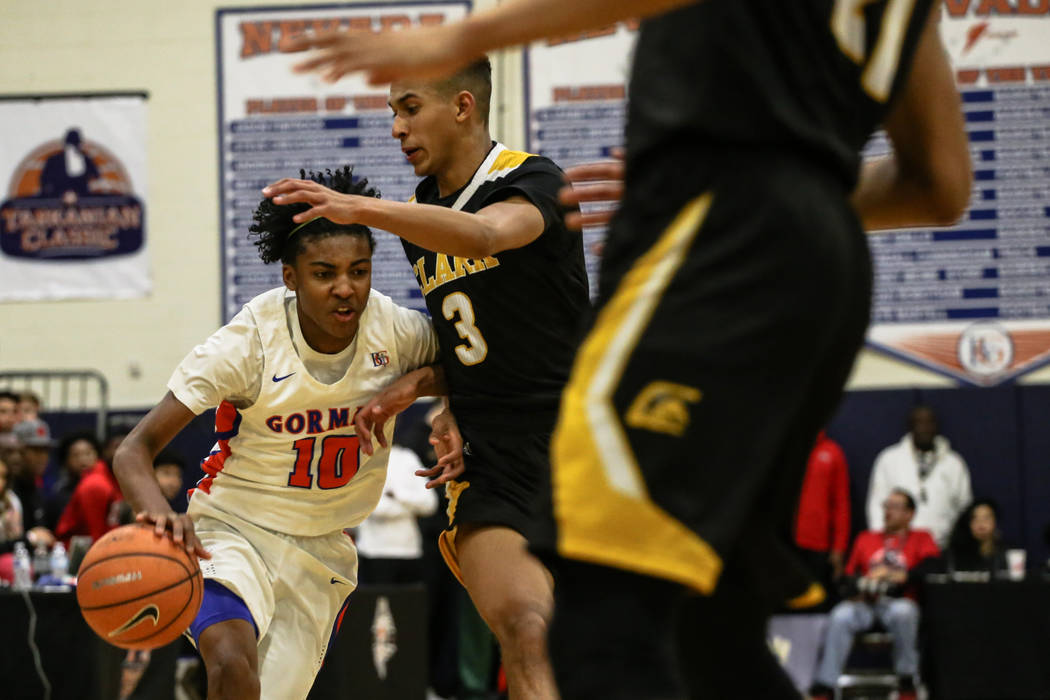 Bishop Gorman's Zaon Collins (10) is guarded by Clark Chargers' Greg Foster Jr (3) during the second half of the platinum division championship basketball game of the Tarkanian Classic at Bishop G ...
