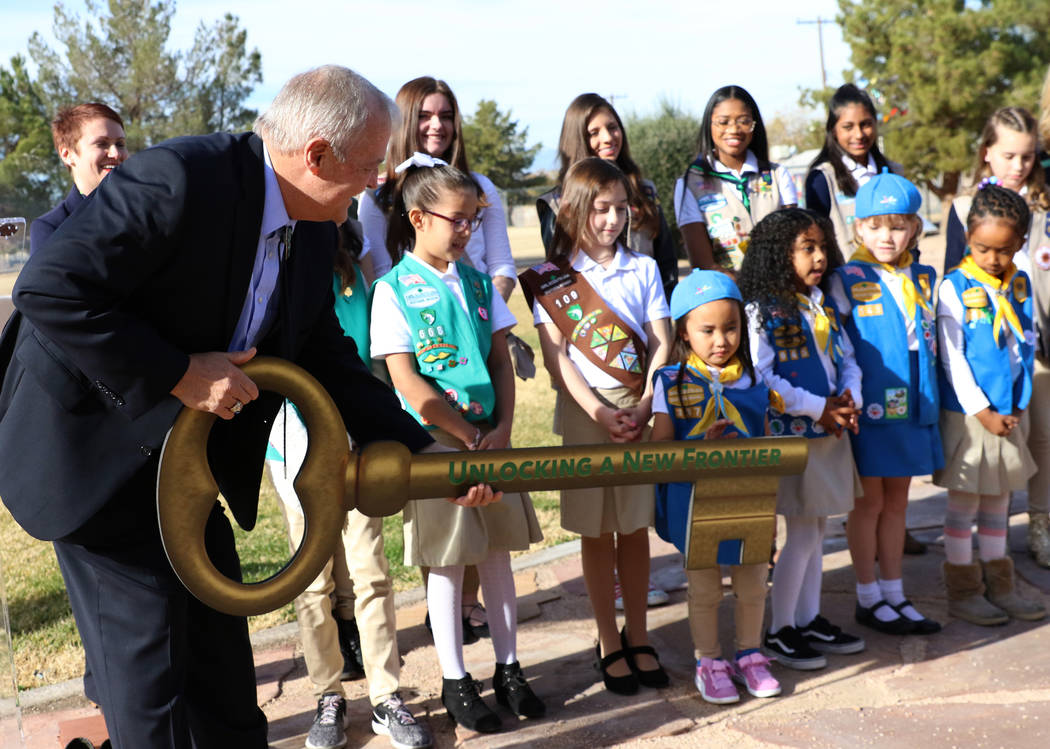 John Mowbray, trustee of the Charles and Phyllis M. Frias Charitable Trust, prepares to pose for a photo with Girl Scouts after a press conference on Tuesday, Dec, 18, 2018, in Las Vegas where he ...