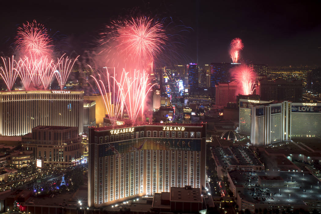 At the stroke of midnight on New Years Eve, fireworks erupt over the Las Vegas Strip in this view looking south from the rooftop of the Trump International Hotel in Las Vegas on Sunday, Jan.1, 201 ...