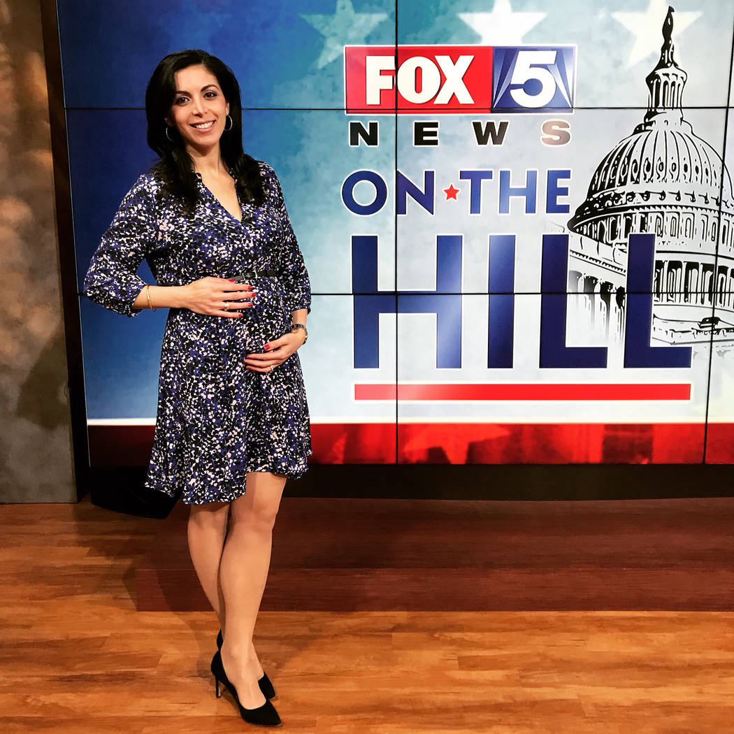 Ronica Cleary, a reporter with Washington, D.C., station Fox5, is shown with her baby bump in a photo posted on her Twitter page with the caption “Take-your-bump-to-work-day!”. (Twitter)