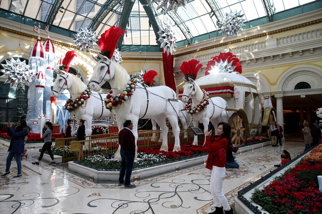 Guests check out the Majestic Holiday Magic at the Bellagio Conservatory & Botanical Gardens in Las Vegas Friday, Dec. 21, 2018. The display will be up through Jan. 6, 2019. K.M. Cannon Las Ve ...