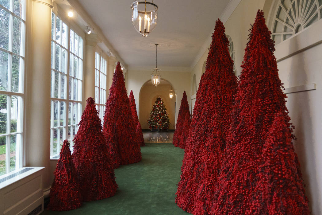 Topiary trees line the East colonnade during the 2018 Christmas Press Preview at the White House in Washington, Monday, Nov. 26, 2018. (AP Photo/Carolyn Kaster)
