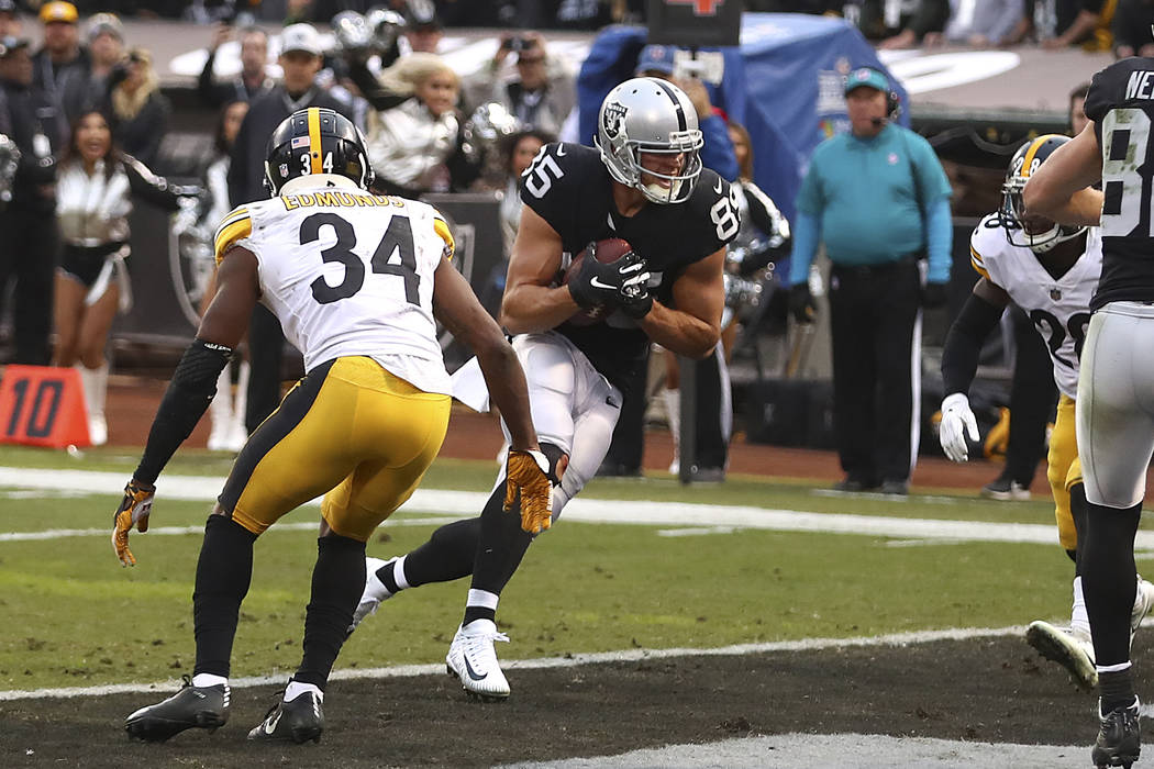 Oakland Raiders tight end Derek Carrier (85) scores against the Pittsburgh Steelers during the second half of an NFL football game in Oakland, Calif., Sunday, Dec. 9, 2018. (AP Photo/Ben Margot)
