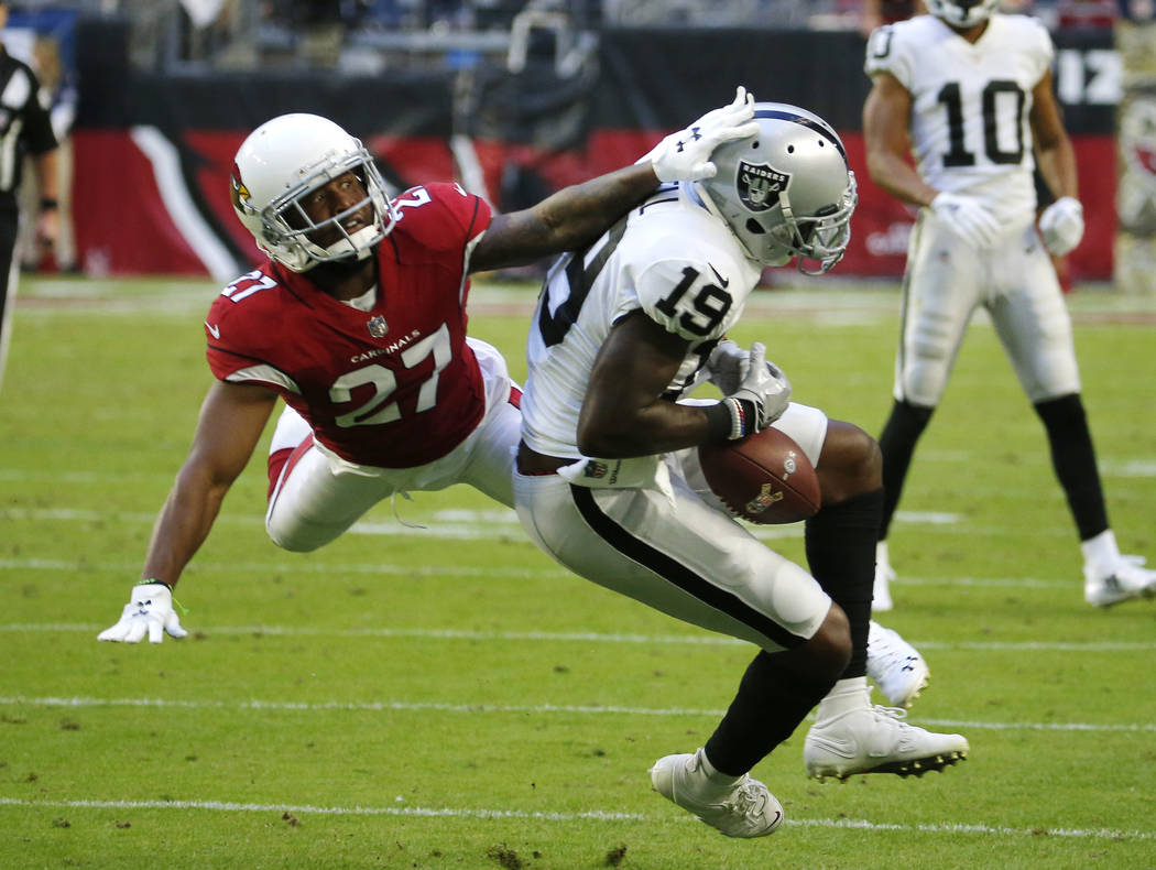 Oakland Raiders wide receiver Brandon LaFell (19) can't make the catch as Arizona Cardinals defensive back Leonard Johnson (27) defends during the second half of an NFL football game, Sunday, Nov. ...