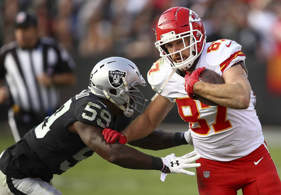 File-This Dec. 2, 2018, file photo shows Kansas City Chiefs tight end Travis Kelce (87) running against Oakland Raiders linebacker Tahir Whitehead (59) during the second half of an NFL football ga ...