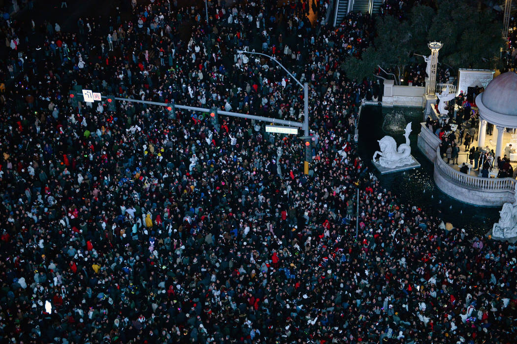 People gather to watch the fireworks go off for the New Year as seen from Drai’s Nightclub on