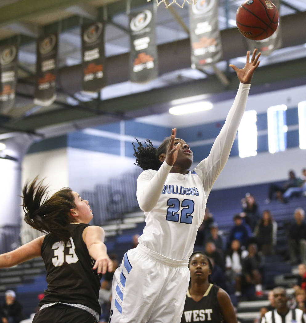 CentennialÕs Eboni Walker (22) goes to the basket past WestÕs Piper Takenaka (33) during a basketball game at Centennial High School in Las Vegas on Saturday, Dec. 29, 2018. Chase Steven ...