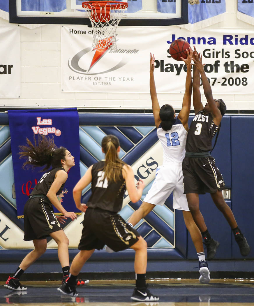 CentennialÕs Aishah Brown (12) blocks a shot from WestÕs Anaya James (3) during a basketball game at Centennial High School in Las Vegas on Saturday, Dec. 29, 2018. Chase Stevens Las Veg ...