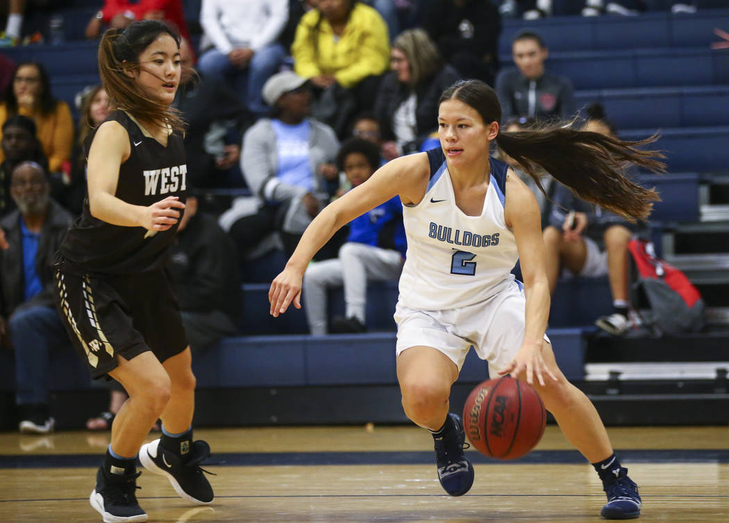 CentennialÕs Melanie Isbell (2) moves the ball around WestÕs Alisa Saito (5) during a basketball game at Centennial High School in Las Vegas on Saturday, Dec. 29, 2018. Chase Stevens Las ...