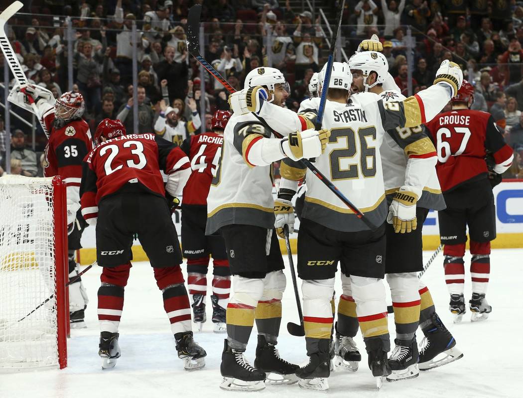 Vegas Golden Knights center Paul Stastny (26) celebrates his goal against the Arizona Coyotes with left wing Valentin Zykov (73) and right wing Alex Tuch (89) as Coyotes goaltender Darcy Kuemper ( ...