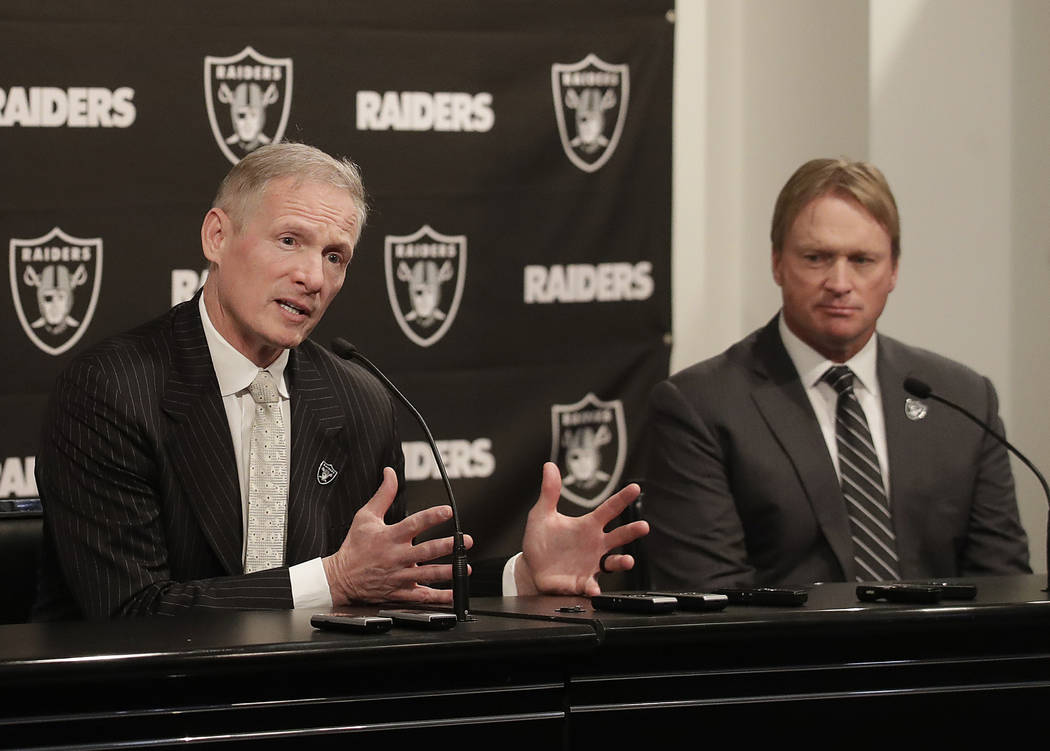 Mike Mayock, left, gestures next to Oakland Raiders head coach Jon Gruden at a news conference announcing Mayock as the general manager at the team's headquarters in Oakland, Calif., Monday, Dec. ...