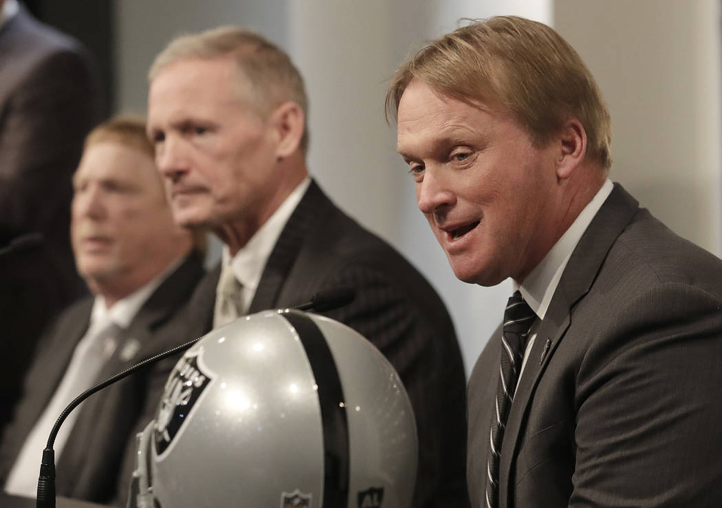 Oakland Raiders head coach Jon Gruden, right, speaks next to Mike Mayock, center, and owner Mark Davis at a news conference announcing Mayock as the general manager at the team's headquarters in O ...