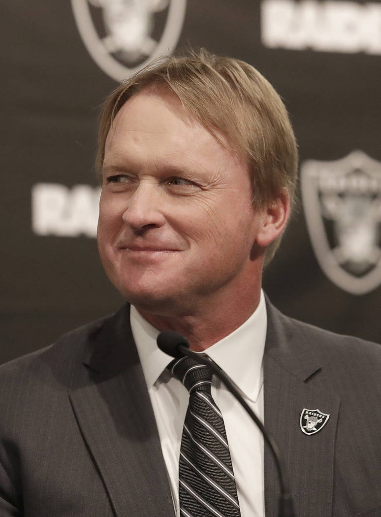 Oakland Raiders head coach Jon Gruden listens to speakers at a news conference announcing Mike Mayock as the team's general manager at the team's headquarters in Oakland, Calif., Monday, Dec. 31, ...