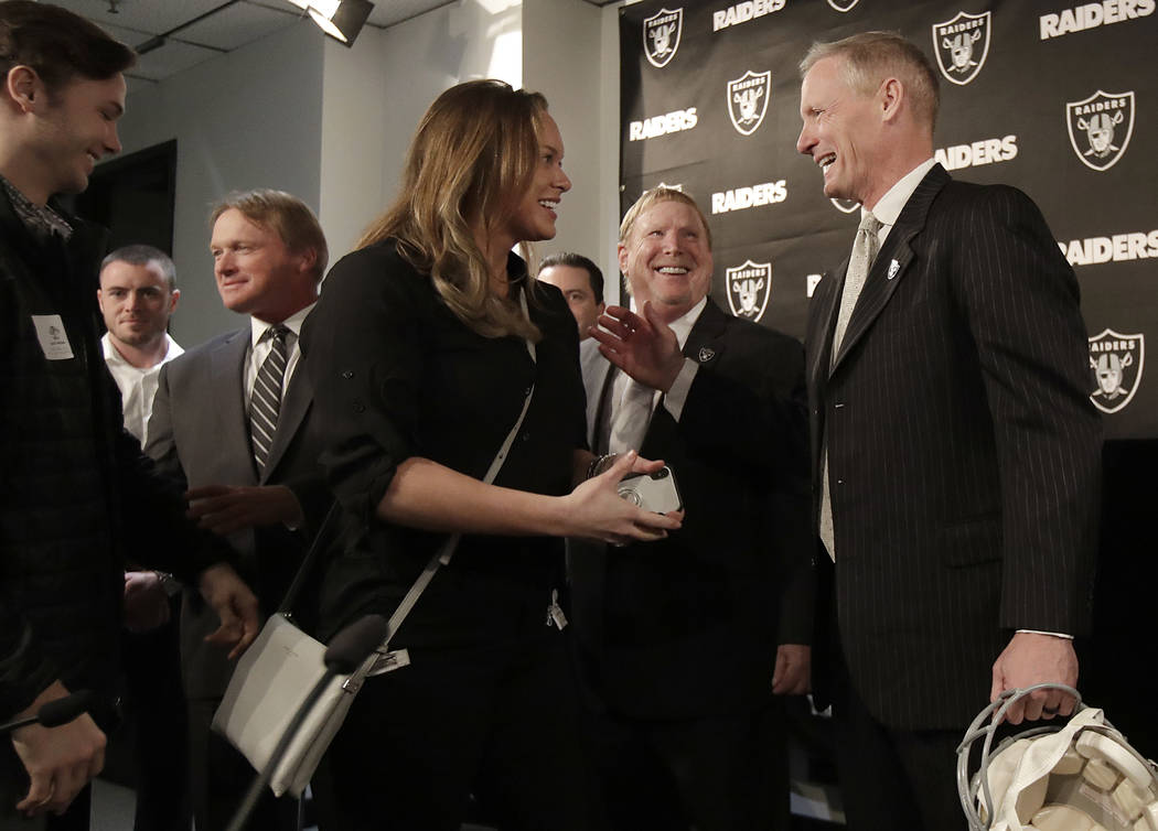 Mike Mayock, right, introduces members of his family to Oakland Raiders owner Mark Davis, second from right, and head coach Jon Gruden, third from left, at a news conference announcing Mayock as t ...
