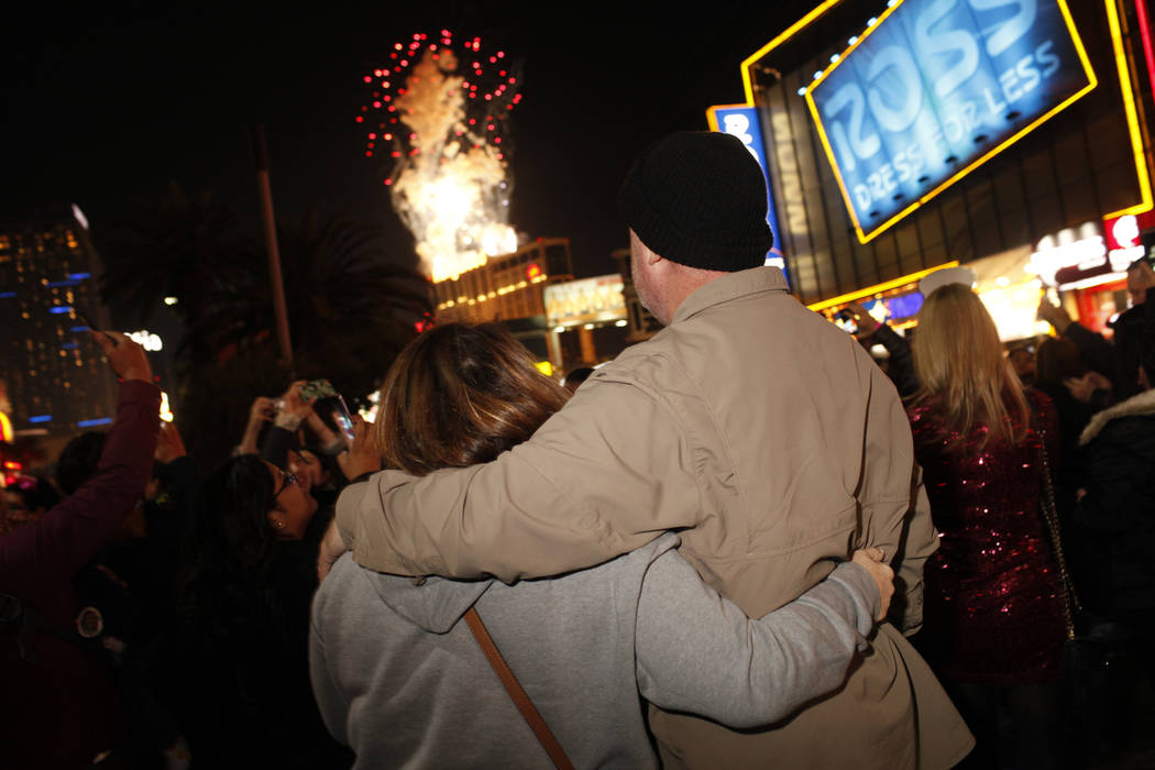 Suzie Gray, 50, left, and Steve Walker of Las Vegas watch fireworks on the Las Vegas Strip during the first minutes of New Year's Day, Jan. 1, 2018. (Joel Angel Juarez/Las Vegas Review-Journal) @j ...