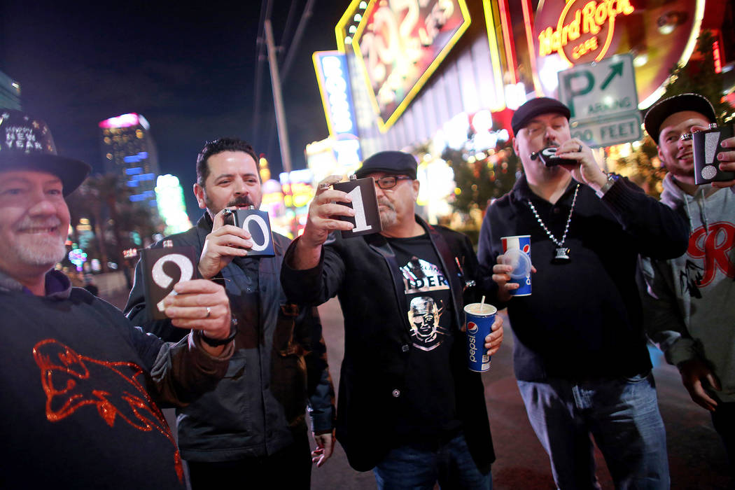 Dave Holtgreven, from left, Angelo Guerrero, Tyrone Greene, Leroy Washington, and Jsutin Walters, all friends from Tacoma, Washington, take shots on the Strip in Las Vegas, Monday, Dec. 31, 2018. ...