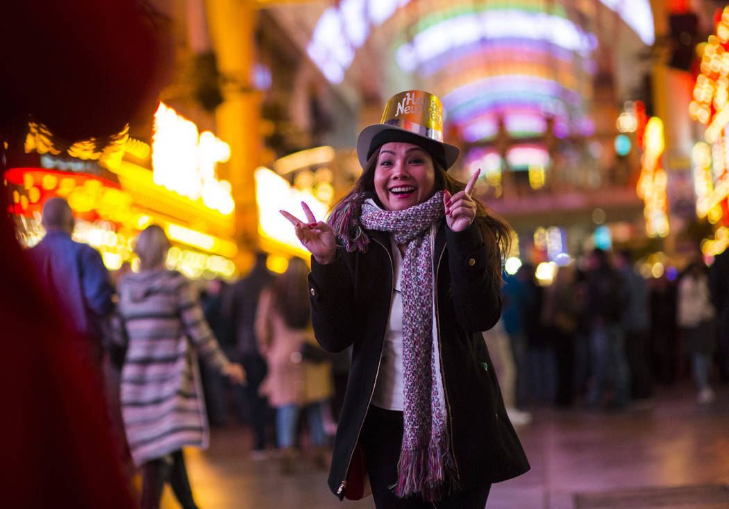 Tammy Dinh of San Diego, Calif., poses for a photo as New Year's Eve revelers gather at the Fremont Street Experience in downtown Las Vegas on Monday, Dec. 31, 2018. Chase Stevens Las Vegas Review ...