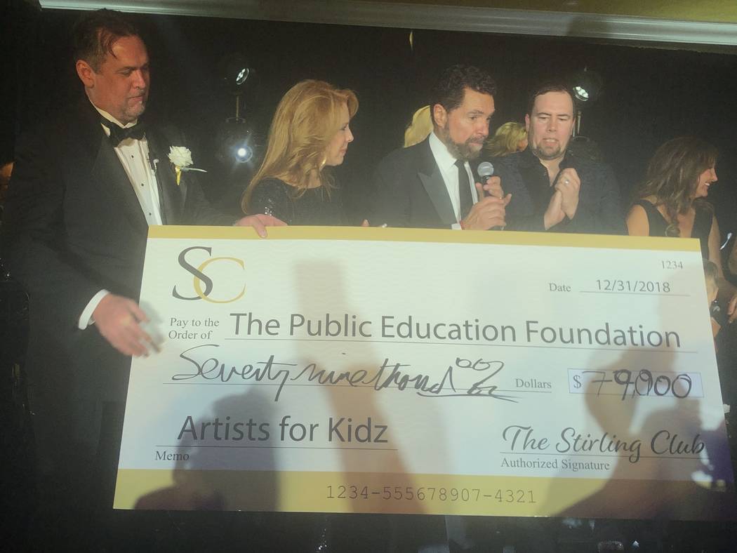 Clint Holmes and Kelly Clinton-Holmes, flanked by Stirling Club Chief Operating Officer Michael Stapleton, far left, are shown accepting a $79,000 check from club owner Richard Ditton for Artists ...