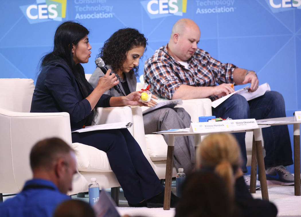 Dr. Ximena Hartstock, founder, chief operating officer and president of Phone2Action and a judge at the competition, far left, asks a question during the student business pitch competition at the ...