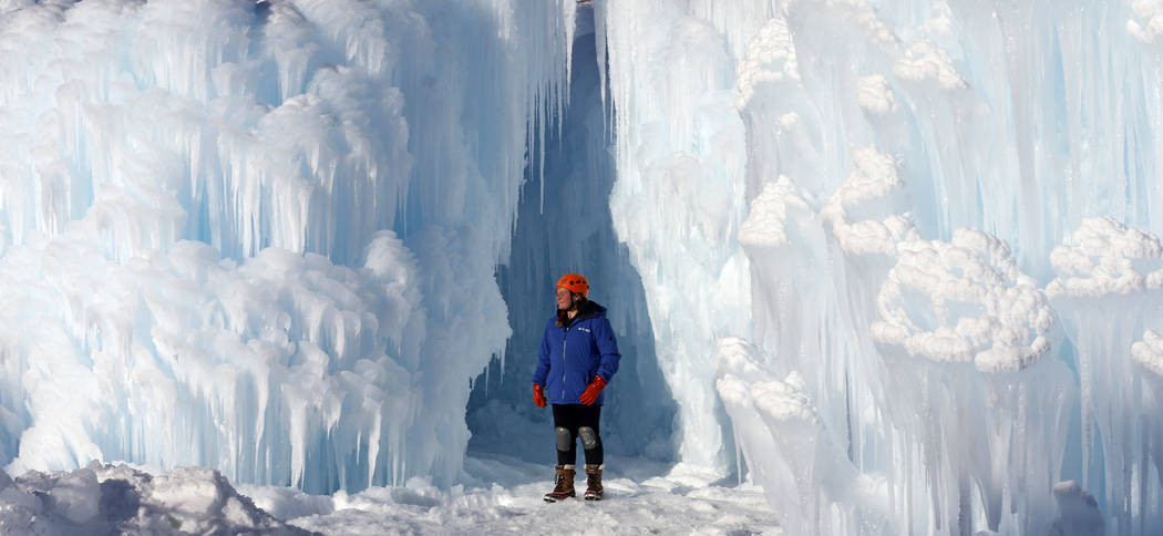 Midway Ice Castles take shape as artisans construct popular winter attraction Wednesday, Jan. 2, 2019, in Midway, Utah. A winter storm has covered cactus with snow in parts of the American Southwe ...