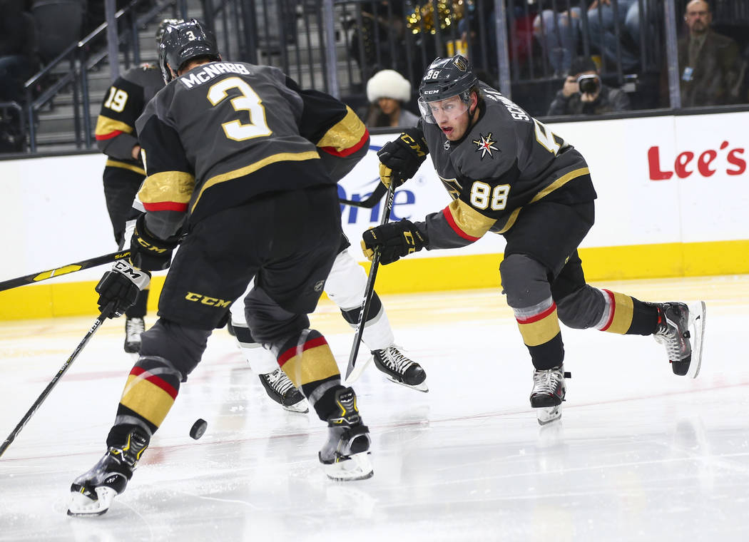 Golden Knights defenseman Nate Schmidt (88) sends the puck past defenseman Brayden McNabb (3) during the second period of an NHL hockey game against the Los Angeles Kings at T-Mobile Arena in Las ...