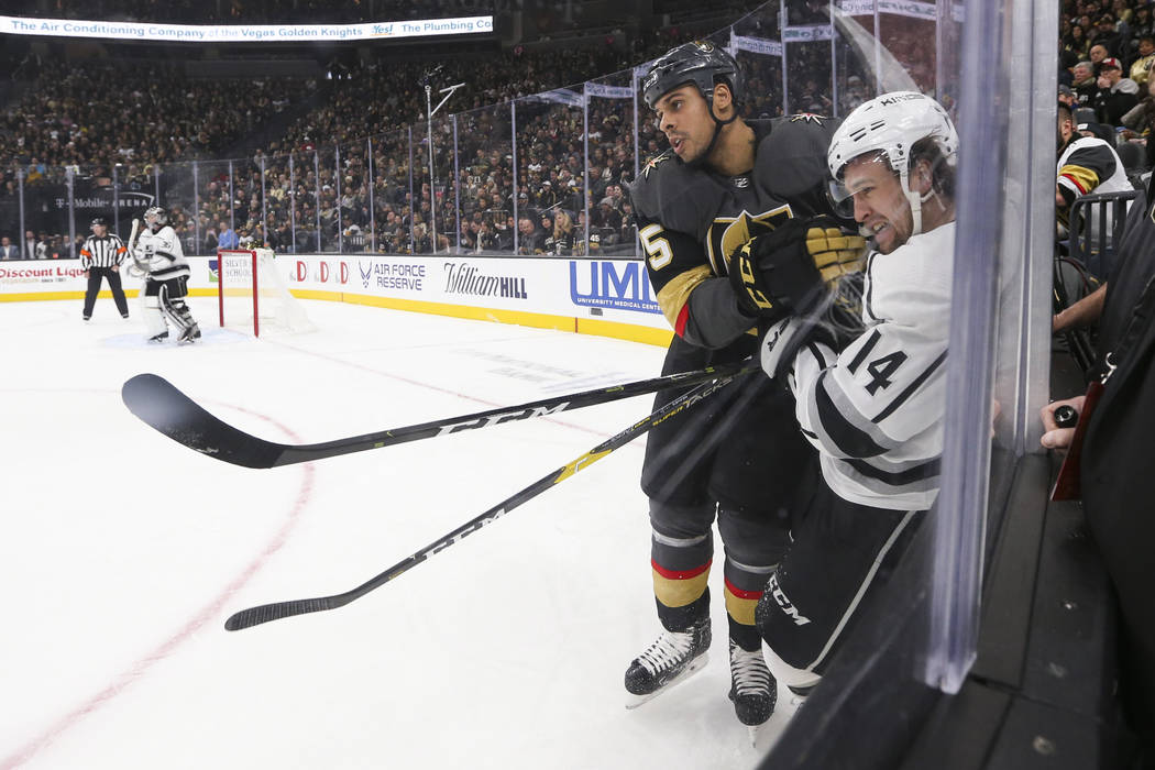 Los Angeles Kings left wing Brendan Leipsic (14) takes a hit from Golden Knights right wing Ryan Reaves (75) during the first period of an NHL hockey game at T-Mobile Arena in Las Vegas on Tuesday ...