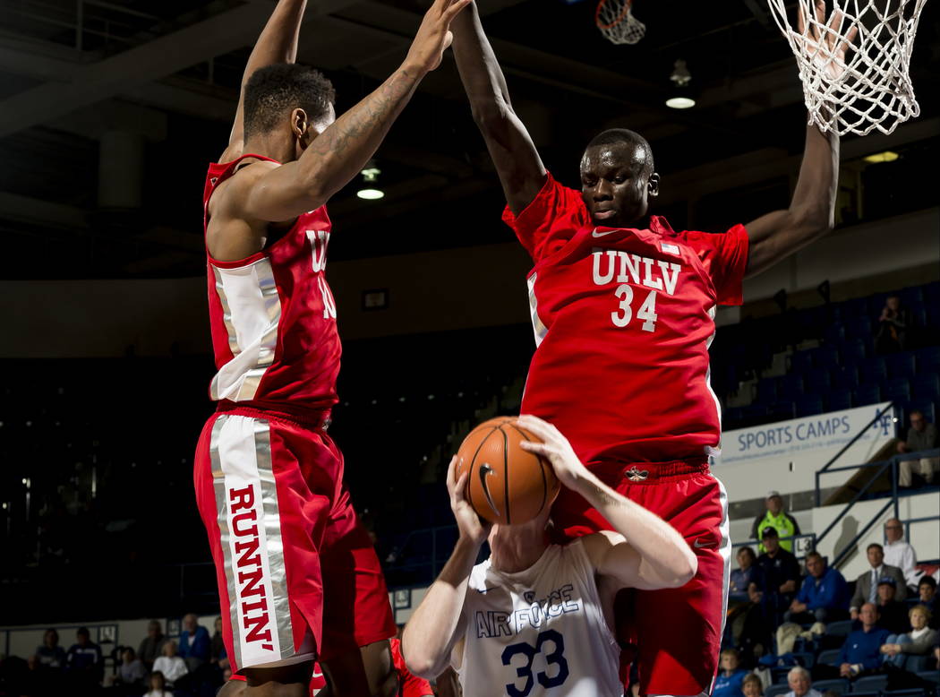 Air Force center Frank Toohey is blocked on his basket attempt by UNLV forwards Shakur Juiston, left, and Cheikh Mbacke Diong (34) during an NCAA college basketball game at Air Force Academy, Colo ...