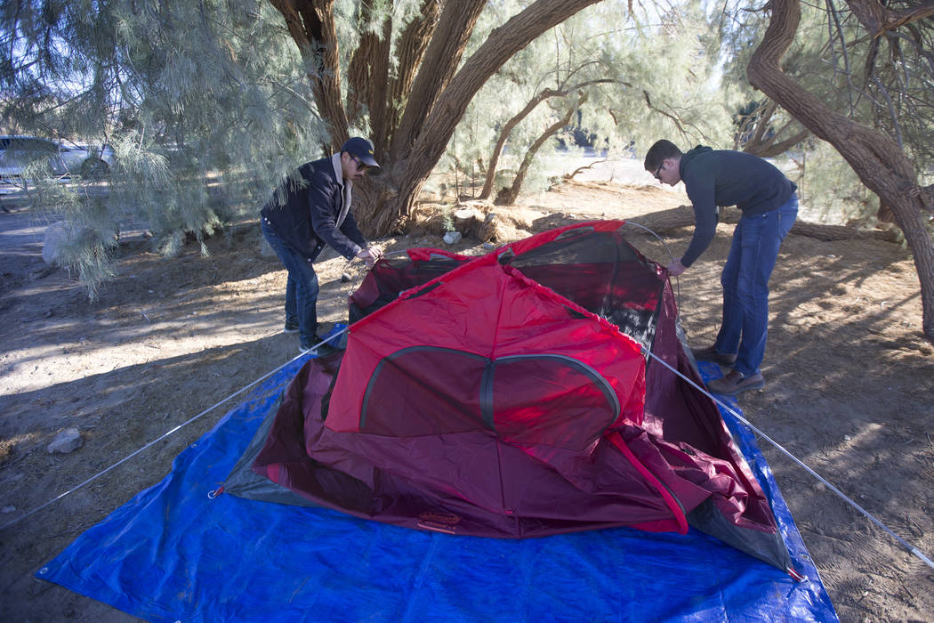 Oscar Arroyo, left, and Kevin Randolph, a couple from Los Angeles, pack up their campsite at the Furnace Creek Campground after campers at the site were forced to move following health and safety ...