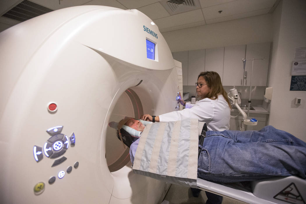 Nuclear Medicine Technologists Vanessa Martinez prepares to conduct the GE 180 scan on Las Vegas resident Jim Pettis at the Cleveland Clinic - Lou Ruvo Center for Brain Health in downtown Las Vega ...