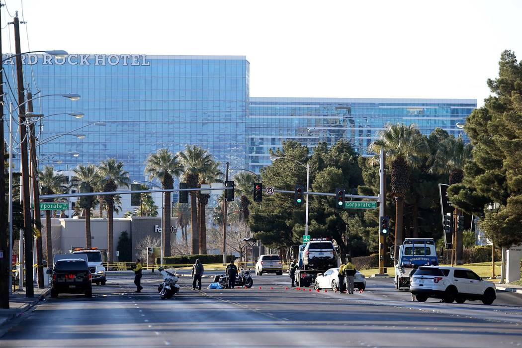 Las Vegas police investigate at Paradise Road near Corporate Drive in Las Vegas Tuesday, Jan. 1, 2018, where a suspected DUI driver crashed into police vehicles, which hit and injured one officer. ...