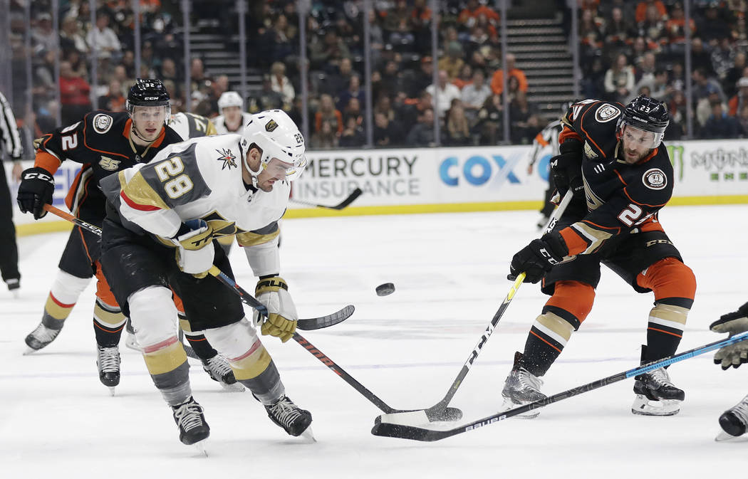 Vegas Golden Knights' William Carrier, left, is defended by Anaheim Ducks' Brian Gibbons, right, during the first period of an NHL hockey game Friday, Jan. 4, 2019, in Anaheim, Calif. (AP Photo/Ma ...