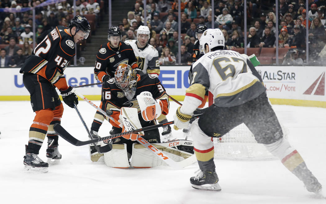 Anaheim Ducks goaltender John Gibson, center, stops a shot from the Vegas Golden Knights during the first period of an NHL hockey game Friday, Jan. 4, 2019, in Anaheim, Calif. (AP Photo/Marcio Jos ...