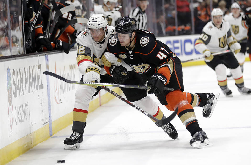 Vegas Golden Knights' Tomas Nosek, left, is defended by Anaheim Ducks' Hampus Lindholm during the first period of an NHL hockey game Friday, Jan. 4, 2019, in Anaheim, Calif. (AP Photo/Marcio Jose ...