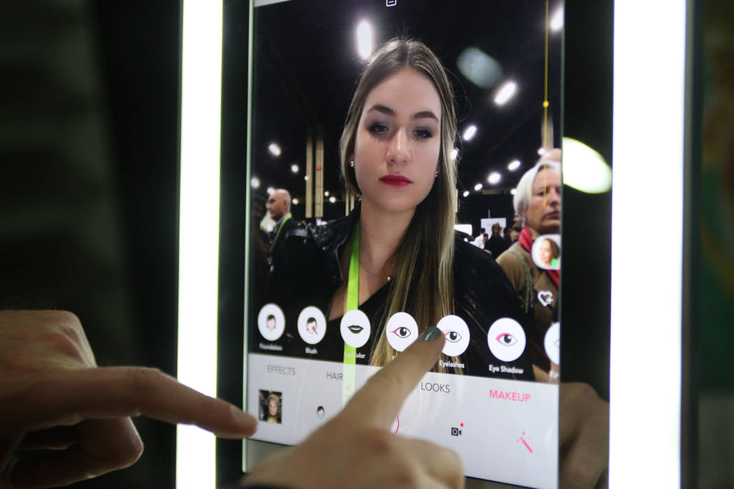 Francesca Vengel uses Perfect Corp.'s YouCam Makeup app to change her makeup at the CES Unveiled event for media prefacing the tech mega-conference at Mandalay Bay in Las Vegas, Sunday, Jan. 6, 20 ...