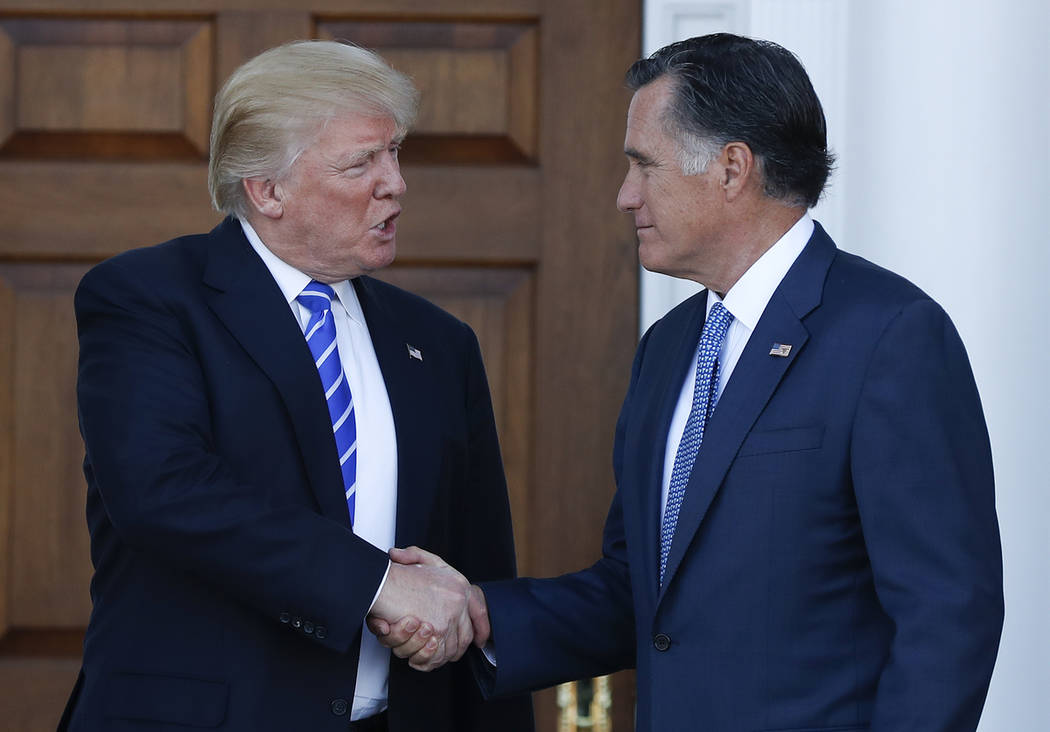 Then-President-elect Donald Trump and Mitt Romney shake hands as Romney leaves Trump National Golf Club Bedminster in Bedminster, N.J. on Nov. 19, 2016. (AP Photo/Carolyn Kaster, file)