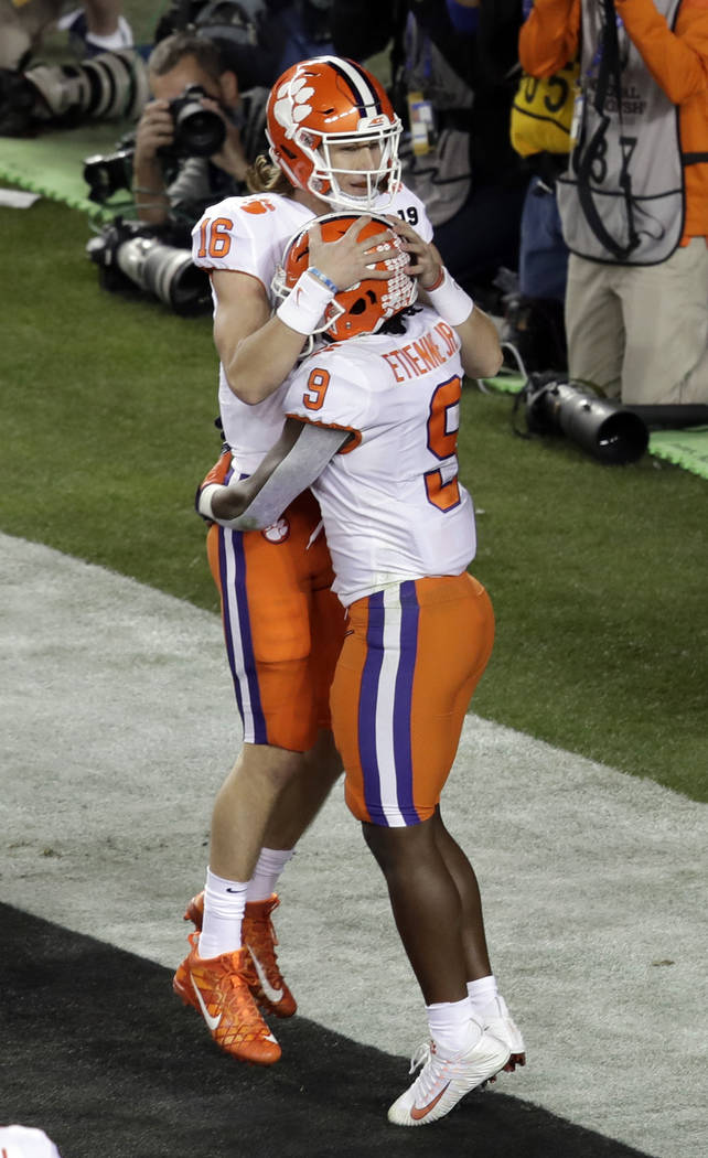 Clemson's Travis Etienne (9) celebrates his touchdown run with Trevor  Lawrence (16) during the first half the NCAA college football playoff  championship game against Alabama, Monday, Jan. 7, 2019, …