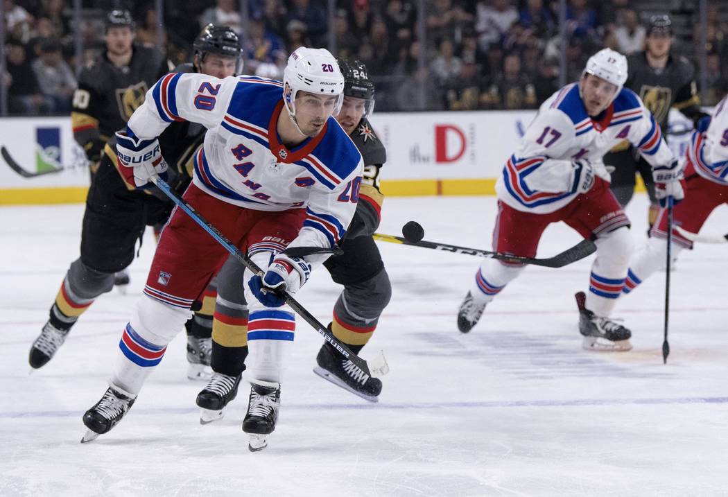 New York Rangers left wing Chris Kreider and Vegas Golden Knights center Oscar Lindberg battle for the puck during the first period of an NHL hockey game Tuesday, Jan. 8, 2019, in Las Vegas. (AP P ...
