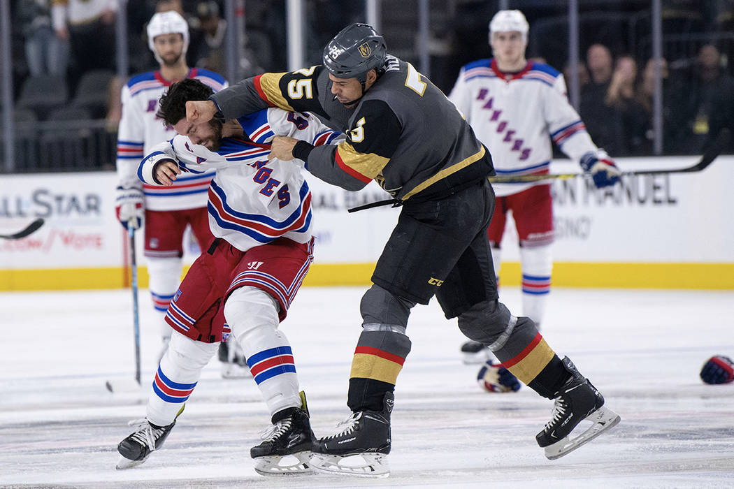 Vegas Golden Knights right wing Ryan Reaves and New York Rangers defenseman Adam McQuaid fight during the third period of an NHL hockey game Tuesday, Jan. 8, 2019, in Las Vegas. (AP Photo/Eric Jam ...