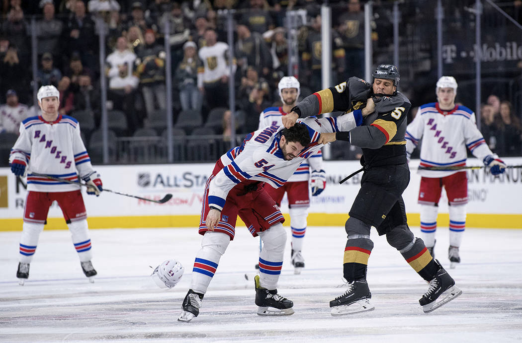 Vegas Golden Knights right wing Ryan Reaves, right front, and New York Rangers defenseman Adam McQuaid fight during the third period of an NHL hockey game Tuesday, Jan. 8, 2019, in Las Vegas. (AP ...